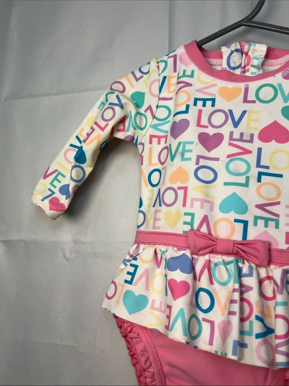 Ruffle Butts pink Love print ruffle bottom one piece rash guard swim-flaw